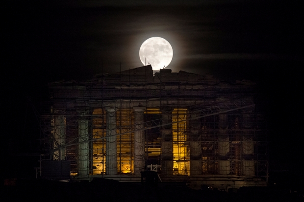 A rising "supermoon" is seen over the Parthenon temple atop the ancient Acropolis hill in Athens, Greece November 14, 2016. REUTERS/Alkis Konstantinidis