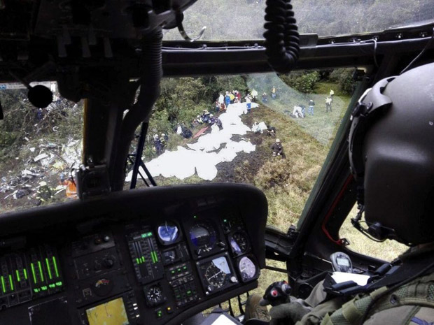 epa05652258 A handout picture provided by Colombian Air Force shows a rescue worker in a helicopter over the site of the plane crash in the municipality of La Union, Department of Antioquia, Colombia, 29 November 2016. According to reports from the Colombian National Police, 75 people died when an aircraft crashed late 28 November 2016 with 81 people on board, including players of the Brazilian soccer club Chapecoense. The plane crashed in a mountainous area outside Medellin, Colombia as it was approaching the Jose Maria Cordoba airport. The cause of the incident is as yet uknown. Chapecoense were scheduled to play in the Copa Sudamericana final against Medellin's Atletico Nacional on 30 November 2016.  EPA/COLOMBIA AIR FORCE / HANDOUT  HANDOUT EDITORIAL USE ONLY